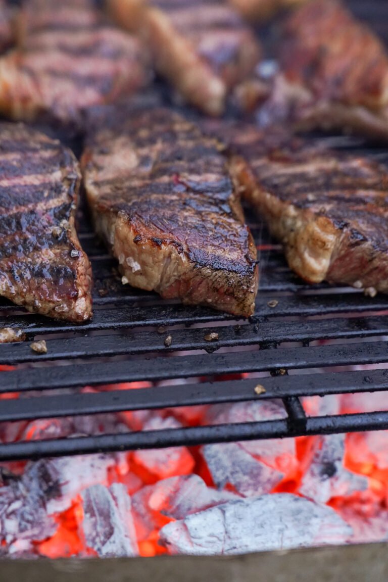 Steak cooking over open flame