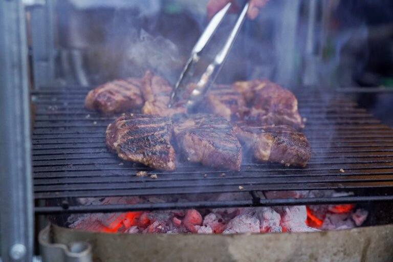 Steak cooking over open flame